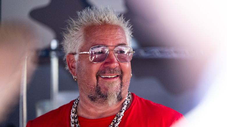 guy fieri smiling in red shirt