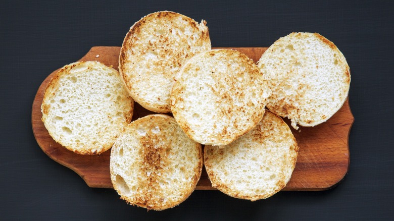 toasted hamburger buns on wooden slab