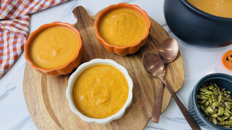 Pumpkin soup in pumpkin shaped serving bowls