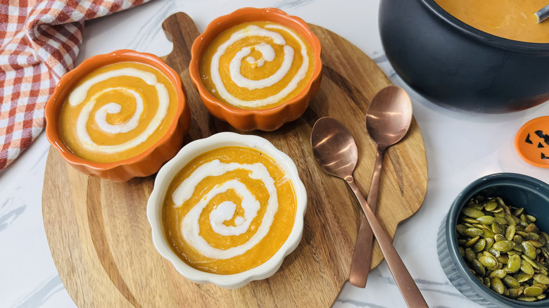 Bowls of pumpkin soup with coconut milk swirls