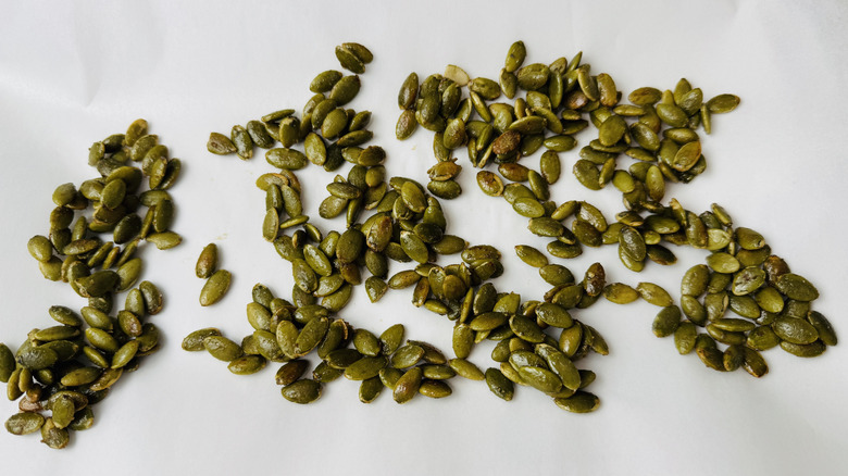 Pumpkin seeds spread out on wax paper
