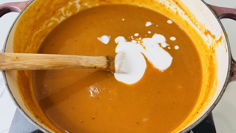 Pumpkin soup with milk in large pot