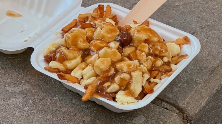 canadian poutine with cheese curds and gravy over french fries