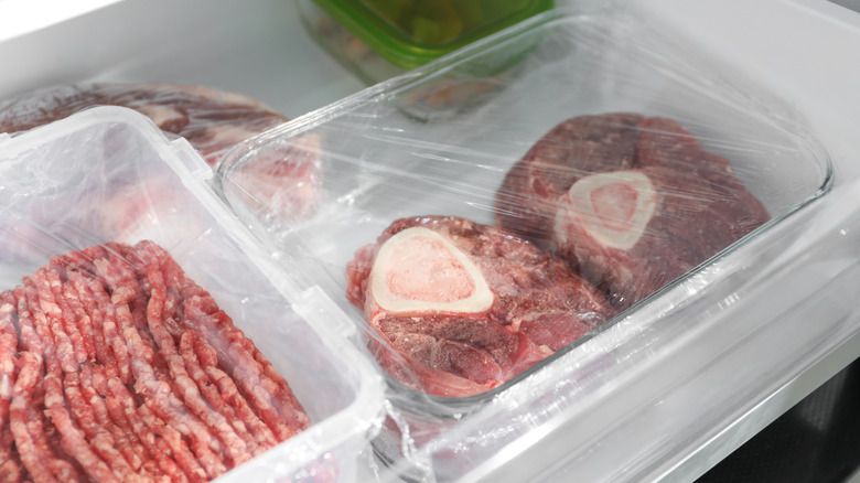 Steaks wrapped in plastic in the fridge