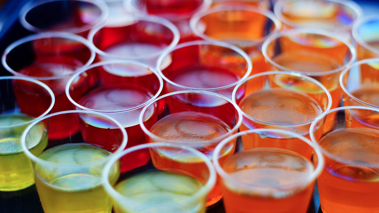 Colorful Jell-O shots in plastic cups closeup