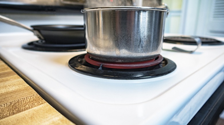 pan simmers on electric burner of stovetop