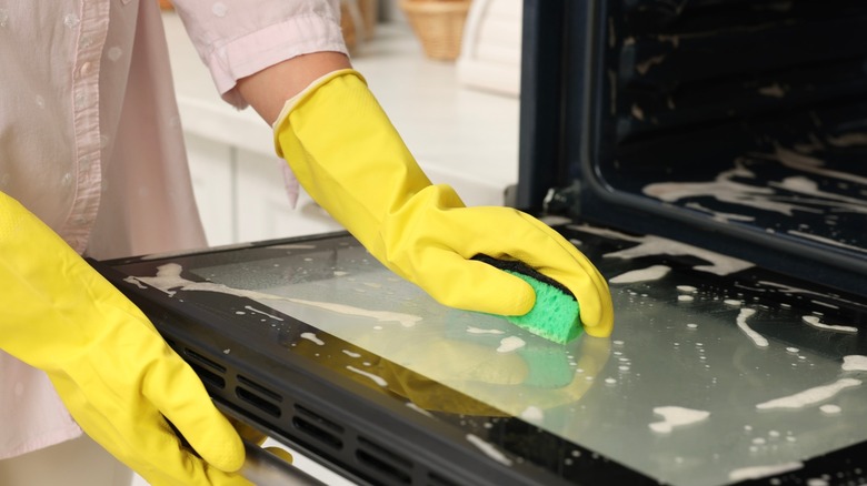 hands scrub oven door