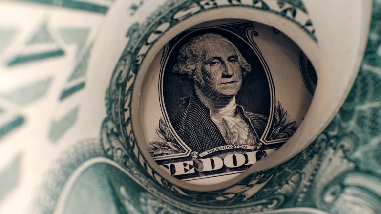 rolled up one-dollar bill