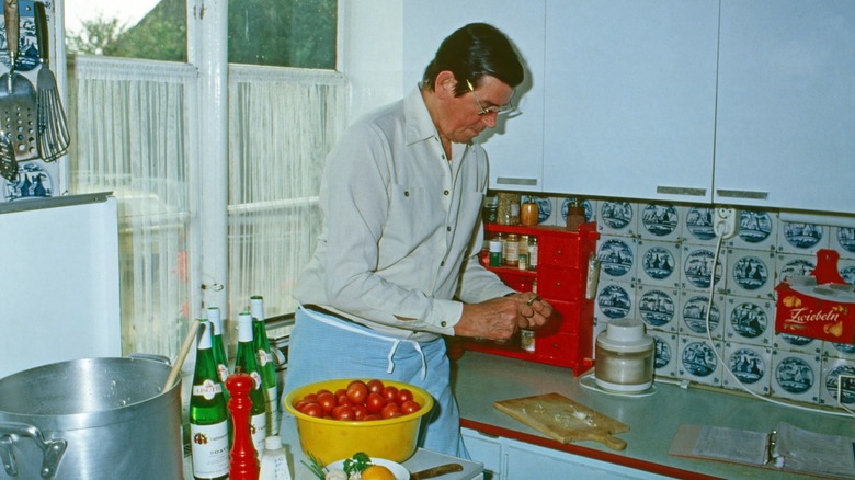 a man cooks in a vintage kitchen
