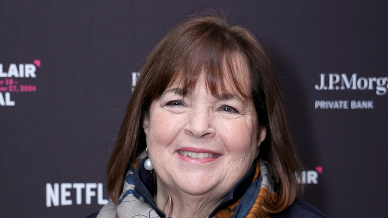 Ina Garten smiling, dark background.