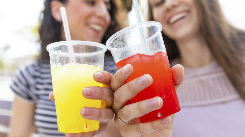 Two women drinking slushies together