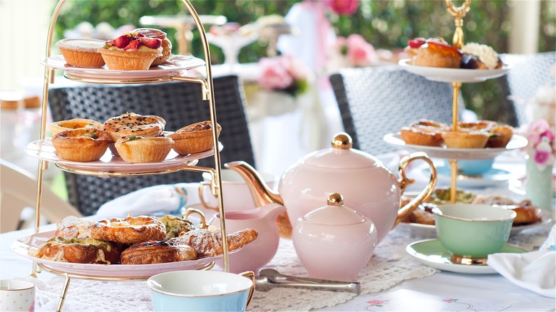 afternoon tea and pastries served on a pastel tea set
