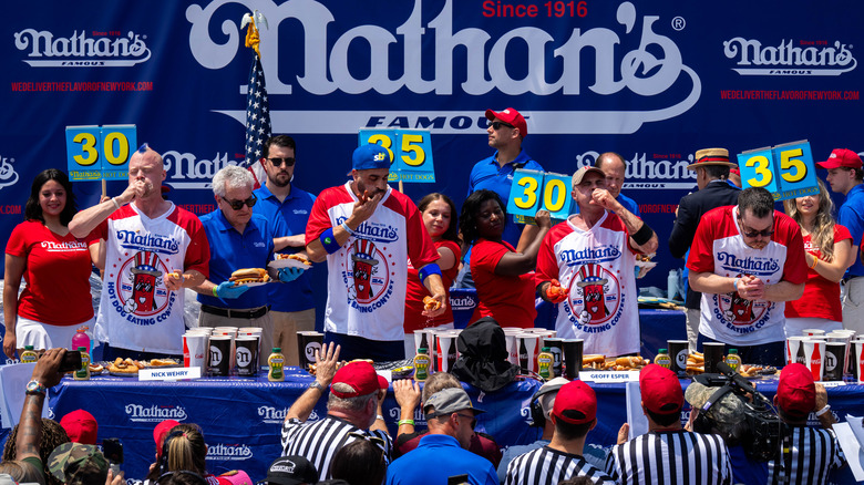 Competitors for the mens title at Nathan's Annual Hot Dog Eating Contest on July 4, 2024. Wehry is on the far left.