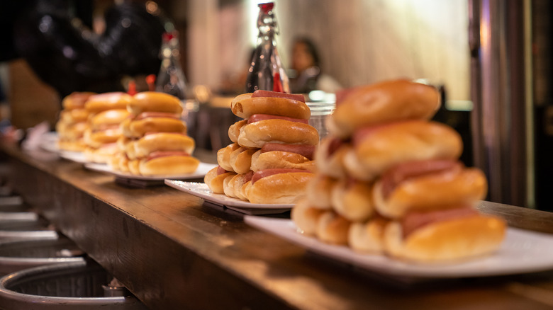 Plates of hot dogs set up for an eating competition
