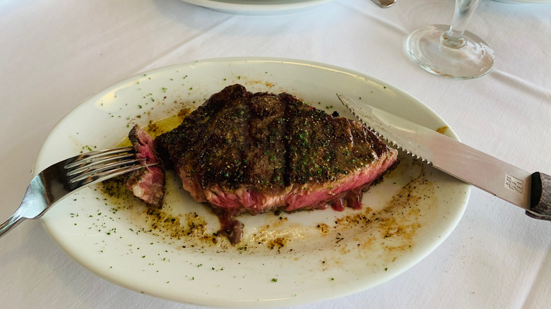 ruth's chris steak on a plate with utensils