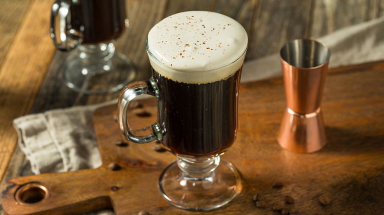 A traditional hot Irish coffee with cream in glass