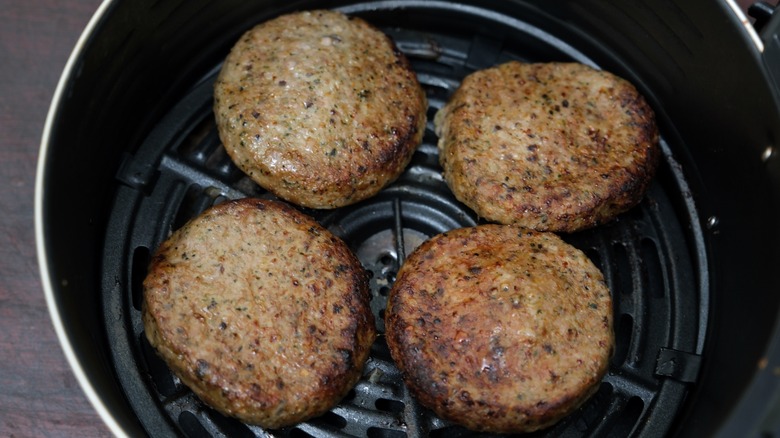 Burgers cooking in an air fryer