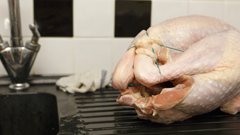 Raw turkey by sink