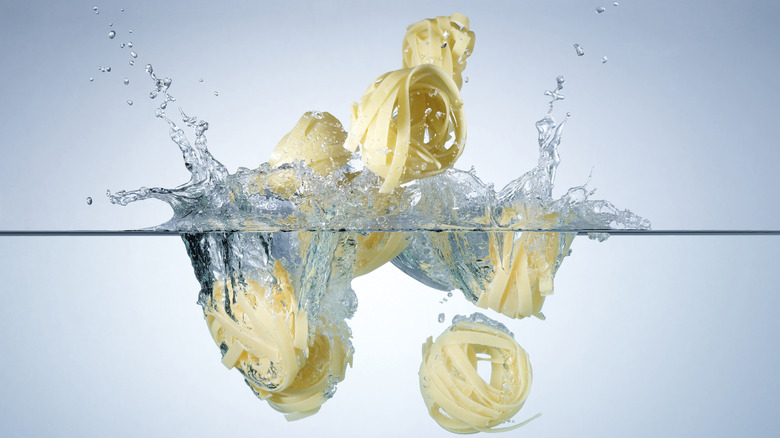 dropping pasta in water
