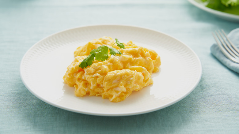 Fluffy scrambled eggs on a white dish