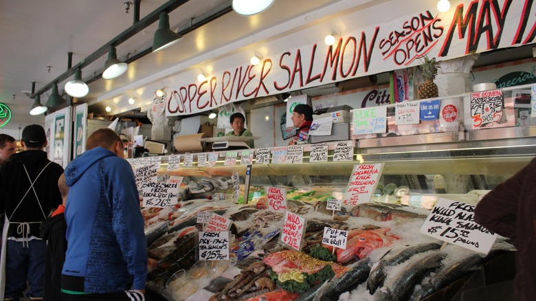 fishmongers sell seafood at pike place market
