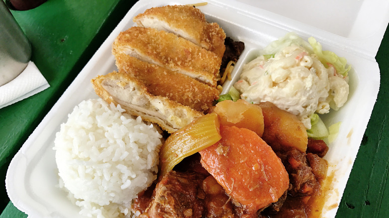 Closeup of a Hawaiian plate lunch with rice, mac salad, and meats.