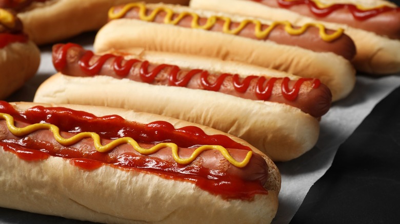 Close up hot dogs in bun with ketchup and mustard