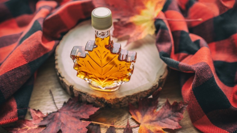 a maple leaf shaped bottle of maple syrup