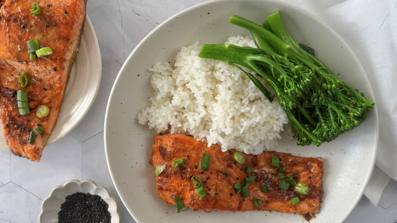 Salmon on plate with rice and broccolini