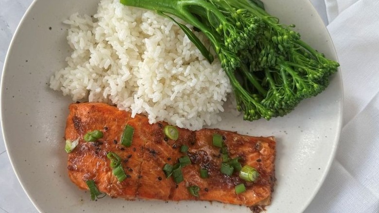 Salmon on plate with rice and broccolini