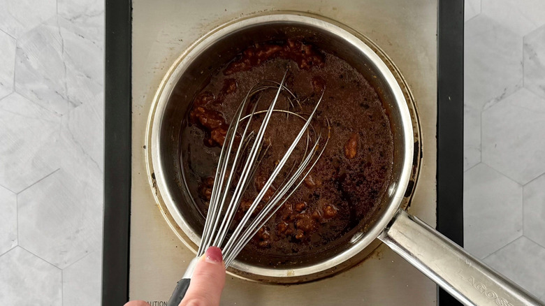 Hand whisking miso glaze in saucepan