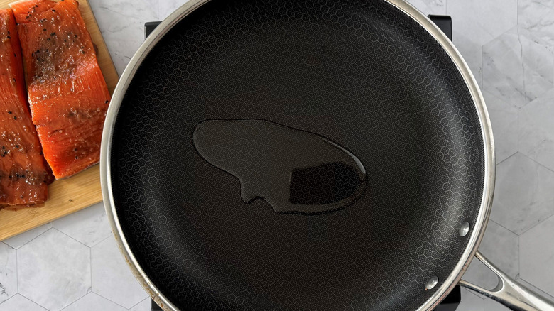 Oil in pan next to salmon