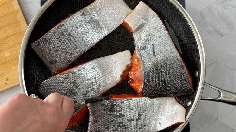 Skin side up salmon filets in pan