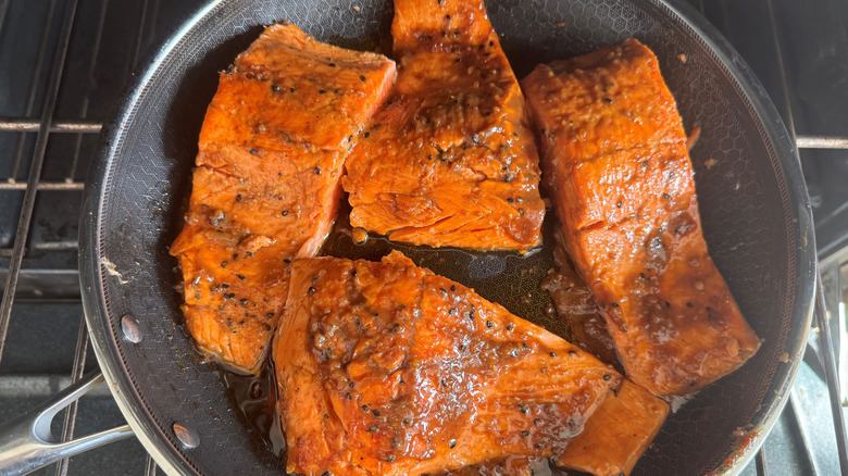 Salmon filets in pan on oven rack