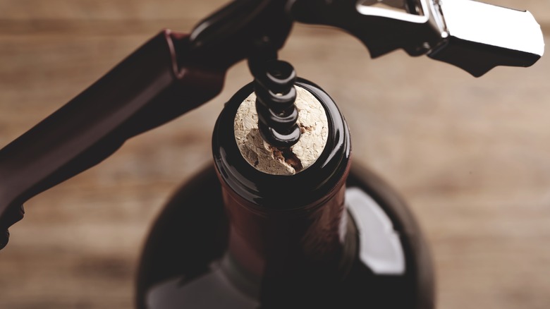 corkscrew in a cracked wine cork