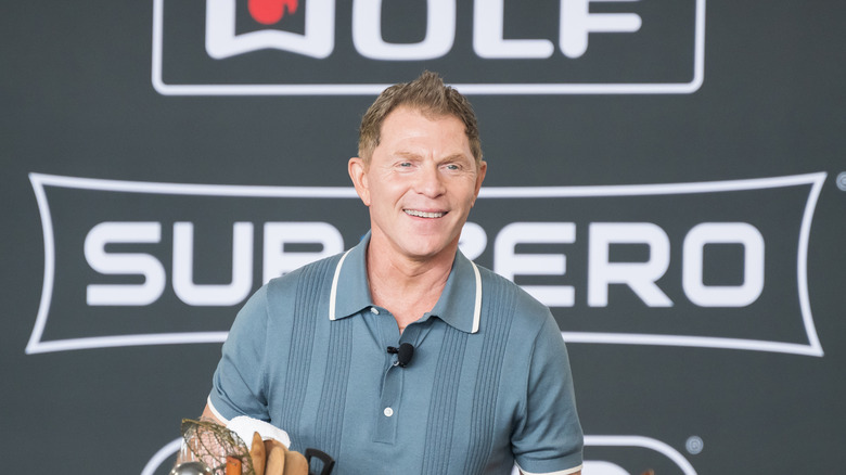 Bobby Flay smiling during cooking demonstration.