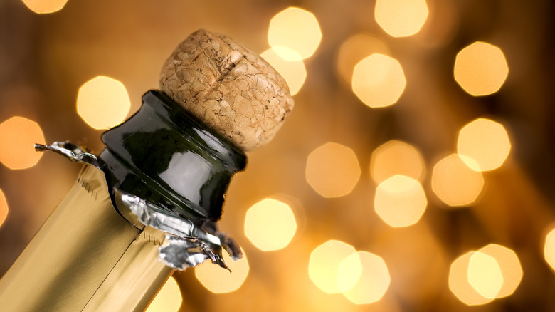 Person opening bottle of Champagne
