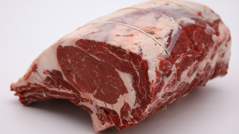 Raw prime rib cut on white background