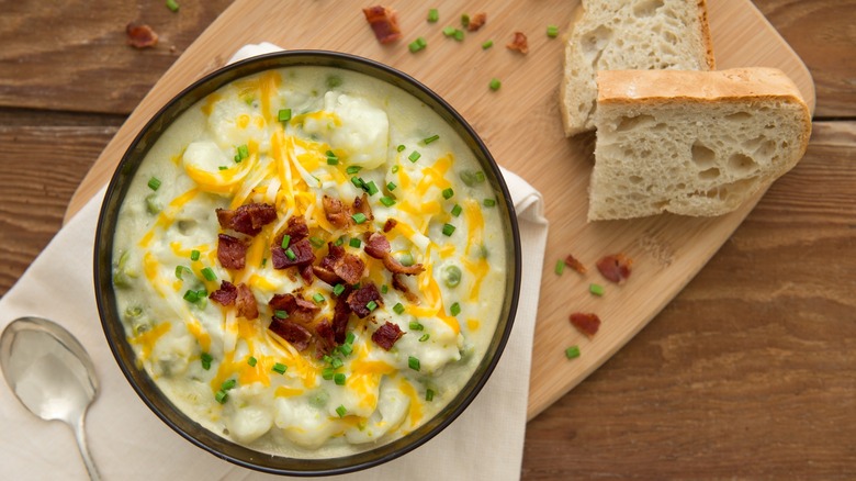 bowl of baked potato soup with sliced bread