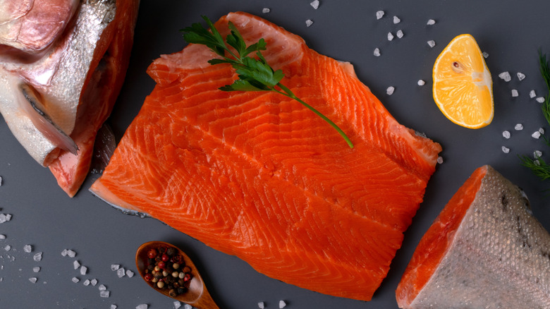Fresh trout cut into pieces on a gray background