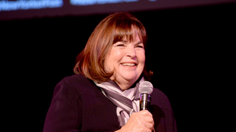 Ina Garten smiling while holding microphone