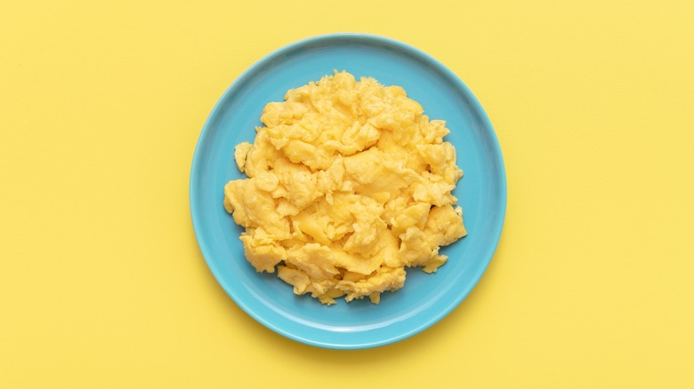fluffy scrambled eggs against yellow background