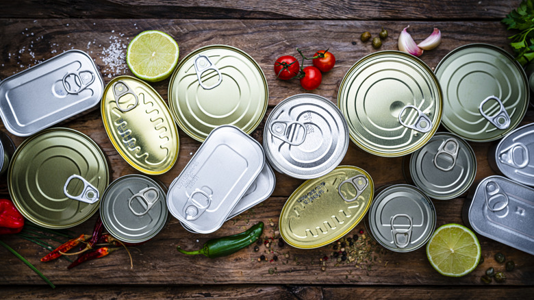 Overhead view of ring-pull cans on wood surface