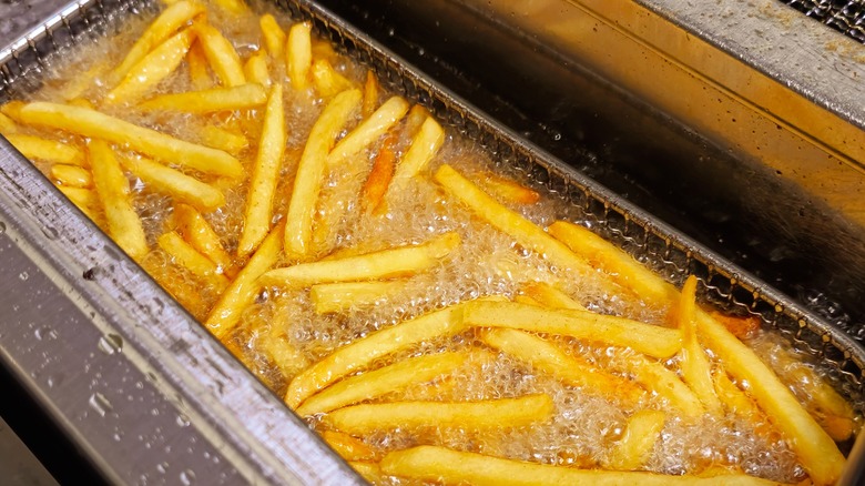 French fires in basket frying in oil