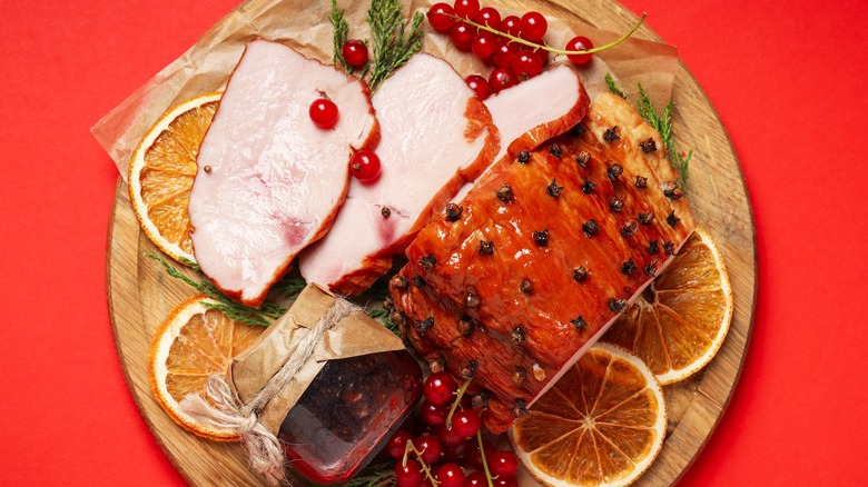 sliced holiday ham on a cutting board