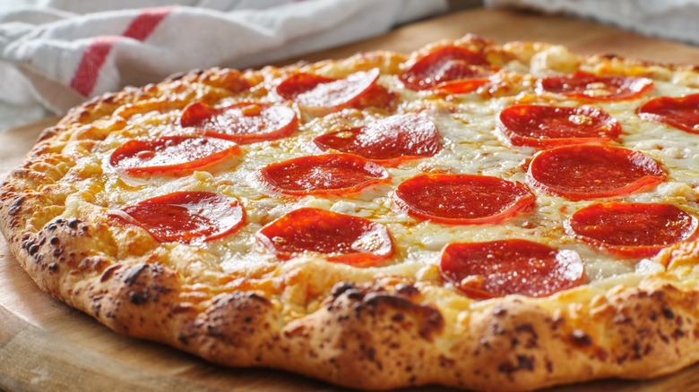 Fully cooked pepperoni pizza close up