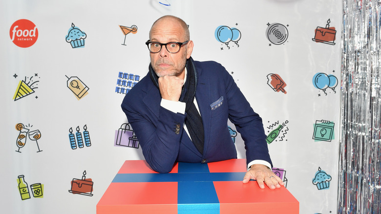 Alton Brown posing with chin on hand at Food Network party, 2018