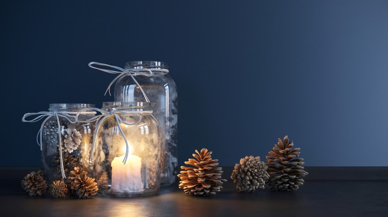 mason jars with candles and pinecones