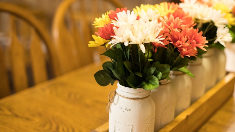 daisies in mason jars with white paint
