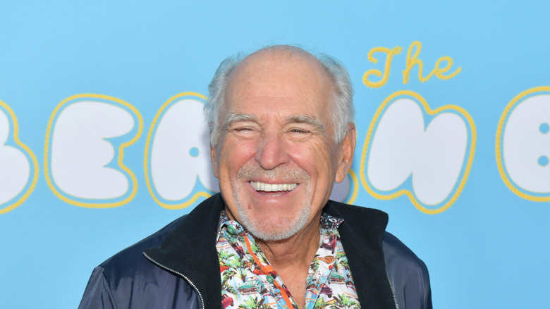 jimmy buffett against blue background on red carpet